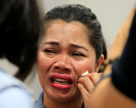 An Overseas Filipino Worker (OFW) from Kuwait cries while being interviewed upon her arrival at Ninoy Aquino International Airport in Pasay city, Metro Manila, Philippines February 21, 2018. Following President Rodrigo Duterte's call to evacuate workers after a Filipina was found dead stuffed inside a freezer. REUTERS/Romeo Ranoco