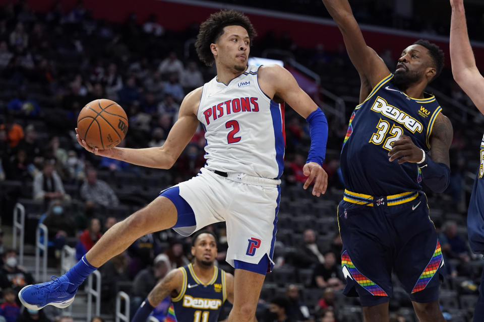 Detroit Pistons guard Cade Cunningham (2) passes the ball as Denver Nuggets forward Jeff Green (32) defends during the second half of an NBA basketball game, Tuesday, Jan. 25, 2022, in Detroit. (AP Photo/Carlos Osorio)