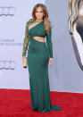 <p>Ditching the deep neckline, the performer rocked an elegant green, maxi bodycon – but still managed a brief glimpse of her well-earned abs. [Photo: Getty] </p>