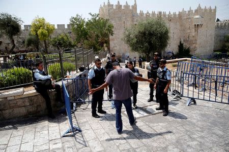 Israeli police check a Palestinian man at the entrance to Jerusalem's Old city on Damascus Gate July 21, 2017. REUTERS/Amir Cohen