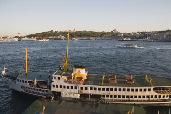 turkey, istanbul, sultanahmet. bosphorous passenger ferry moored at sunset with the hagia sophia behind.