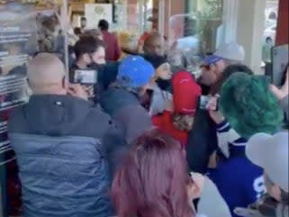 <p>A video captured by a bystander shows a crowd of maskless people pushing to get into a store</p> (Screengrab)