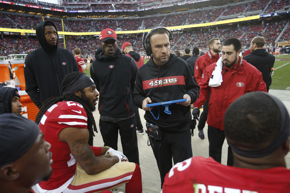 Defensive backs coach Jeff Hafley talks with San Francisco 49ers DBs on the sideline during a game against the Seattle Seahawks on Dec. 16, 2018. (Michael Zagaris/Getty Images)