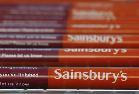 Shopping trolleys are seen parked at a Sainsbury's supermarket at Pulborough, southern England January 8, 2014. REUTERS/Luke MacGregor