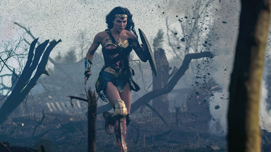  Gal Gadot running across a battlefield in Wonder Woman. 