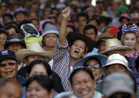 A farmer reacts as she takes part in a rally demanding the Yingluck administration resolve delays in payment, at the Commerce Ministry in Nonthaburi province, on the outskirts of Bangkok February 19, 2014. REUTERS/Chaiwat Subprasom