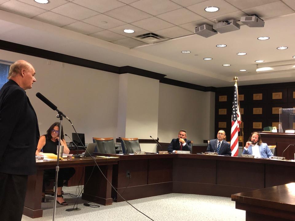 George Enslin, owner of Enslin's LLC/G&S Car Service, left, addresses the Morristown Council during a public hearing in which the council voted to revoke his company's license Tuesday, Sept. 12, 2023.