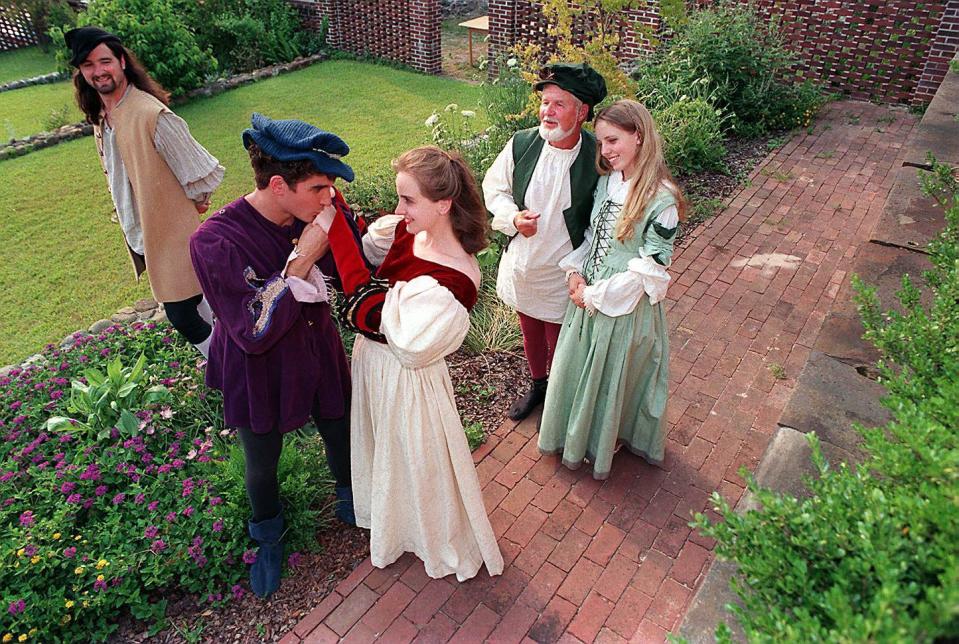 David Crook kisses the hand of Ellen Lee, center, in "The Taming Of The Shrew" from Cape Fear Shakespeare, 1995.