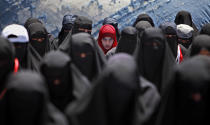 <p>A female anti-government protestor, center, wearing a red scarf, looks on while praying with other women during a demonstration demanding the resignation of Yemeni President Ali Abdullah Saleh, in Sanaa,Yemen, April 6, 2011. (Photo: Muhammed Muheisen/AP) </p>