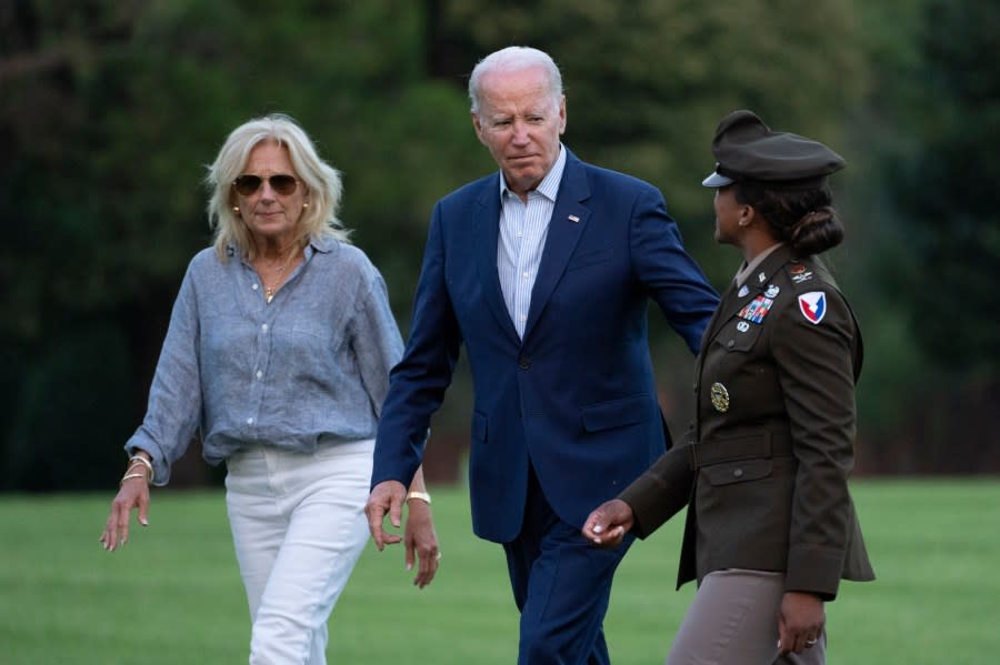 President Joe Biden and first lady Jill Biden are greeted by Col. Tasha Lowery as they arrive at Fort Lesley J. McNair from Camp David, Sunday, July 16, 2023, in Washington. (AP Photo/Manuel Balce Ceneta)