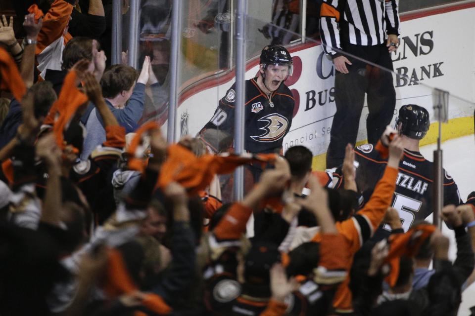 The fans cheer as Anaheim Ducks' Corey Perry, center, and Ryan Getzlaf celebrate a goal by Perry during the second period in Game 2 of the first-round NHL hockey Stanley Cup playoff series against the Dallas Stars on Friday, April 18, 2014, in Anaheim, Calif. (AP Photo/Jae C. Hong)