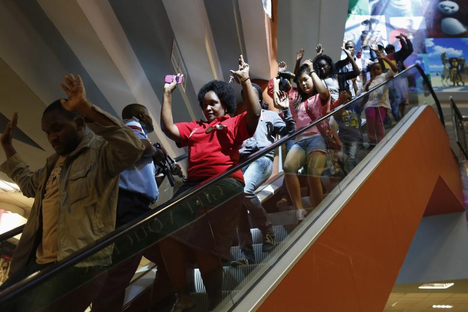 Civilians escape an area at the Westgate Shopping Center in Nairobi September 21, 2013. (REUTERS/Siegfried Modola)