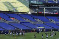 Baltimore Ravens warm up during an NFL football training camp practice in an empty stadium, Saturday, Aug. 29, 2020, in Baltimore, Md.(AP Photo/Gail Burton)