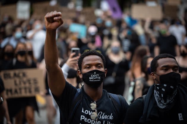 A man wearing a face mask that says