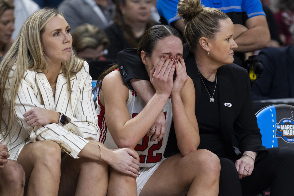 Utah's Jenna Johnson (22) is comforted by head coach Lynne Roberts, right, after missing two free throws that could have tied or put the team in the lead late in the second half against LSU during a Sweet 16 college basketball game of the NCAA Tournament in Greenville, S.C., Friday, March 24, 2023. (AP Photo/Mic Smith)