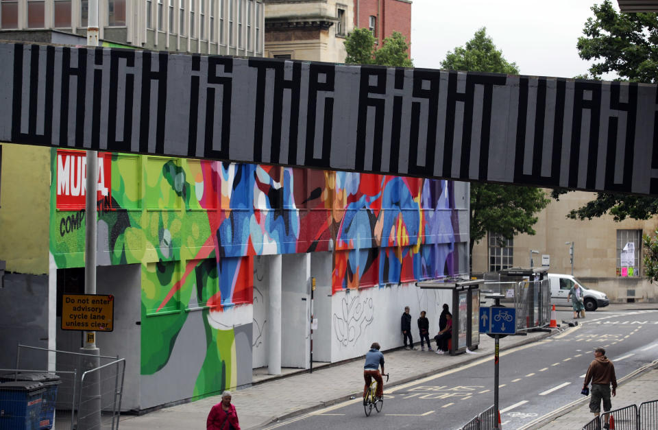 BRISTOL, ENGLAND - AUGUST 17: People walk past the 'See No Evil' street art project at Nelson Street on August 17, 2012 in Bristol, England. The project, now in its second year, is Europe's biggest street art festival and has attracted top graffiti artists from all over the world. Organizers hope it will continue to be a draw for tourists visiting Bristol, often seen the spiritual home of underground artist Banksy. (Photo by Matt Cardy/Getty Images)