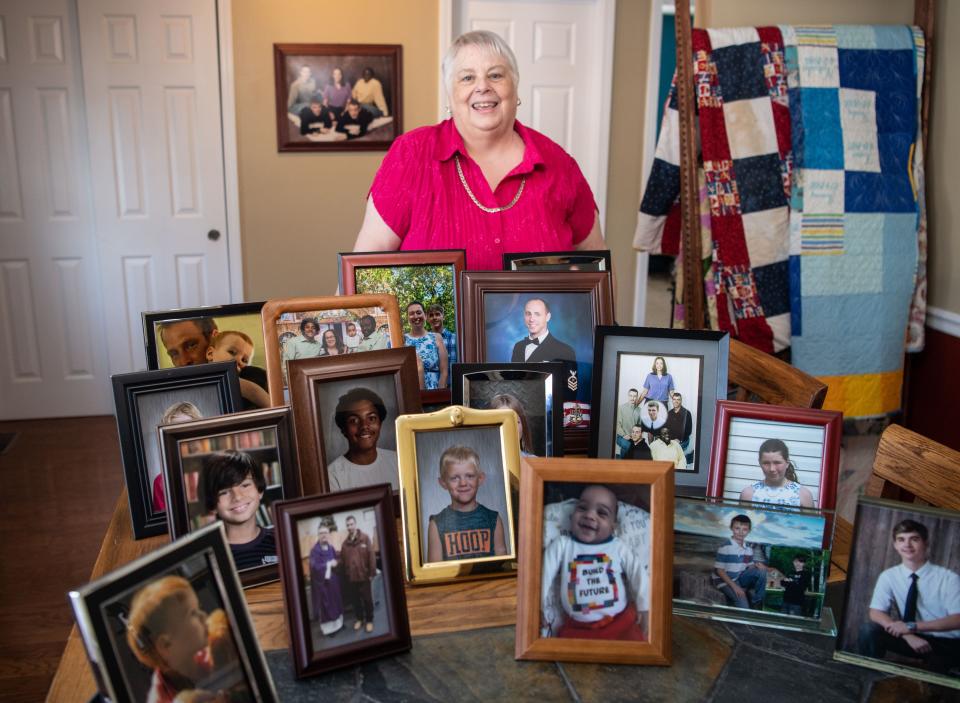 Spring Hill City Administrator Pam Caskie poses in her home last month in Spring Hill, Tenn., surrounded by portraits of her children and grandchildren.