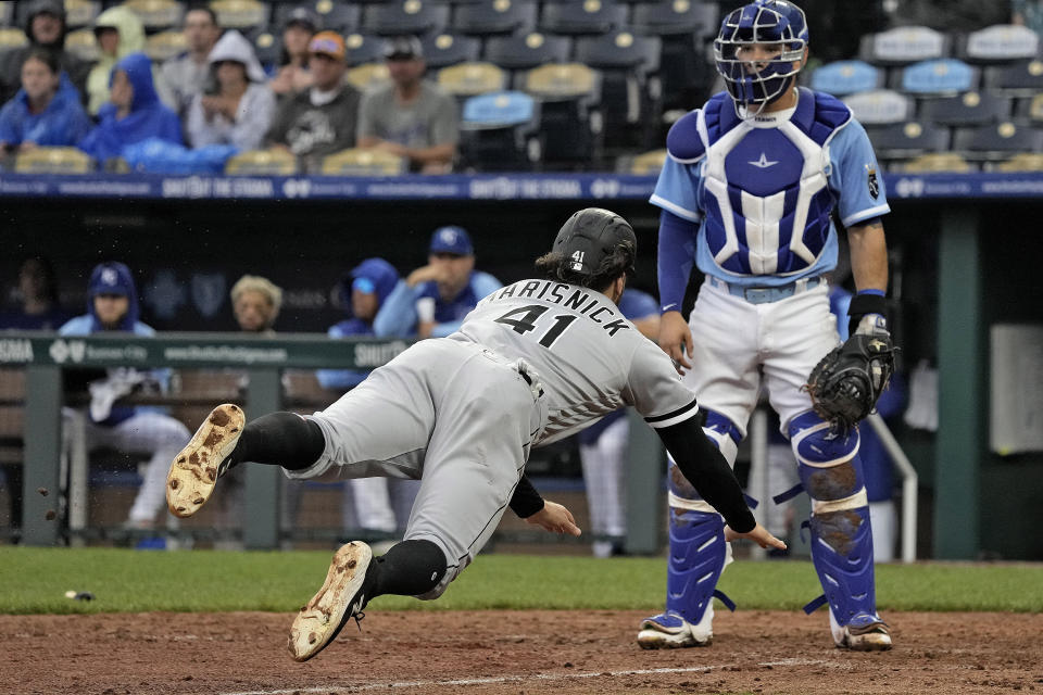 Chicago White Sox's Jake Marisnick dives home to score on a two-run double hit by Luis Robert Jr. during the eighth inning of a baseball game against the Kansas City Royals Thursday, May 11, 2023, in Kansas City, Mo. The Royals won 4-3. (AP Photo/Charlie Riedel)