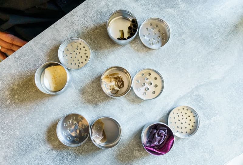 Various metal cans containing odour samples for Gooods Kulava Kutiva's training. Andreas Arnold/dpa