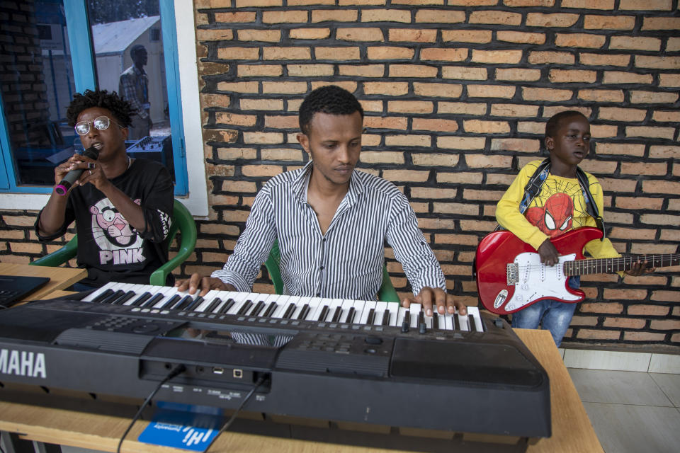 People who were evacuated from Libya to Rwanda play music in the Gashora transit center for refugees and asylum-seekers, in the Bugesera district of Rwanda Friday, June 10, 2022. As Britain plans to send its first group of asylum-seekers to Rwanda amid outcries and legal challenges, some who came there from Libya under earlier arrangements with the United Nations say the new arrivals can expect a difficult time ahead. (AP Photo)