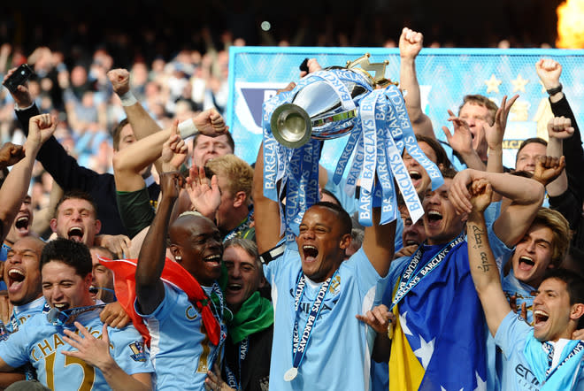 Manchester City's Belgian captain Vincent Kompany lifts the Premier league trophy after their 3-2 victory over Queens Park Rangers in the English Premier League football match between Manchester City and Queens Park Rangers at The Etihad stadium in Manchester, north-west England on May 13, 2012. Manchester City won the game 3-2 to secure their first title since 1968. This is the first time that the Premier league title has been decided on goal-difference, Manchester City and Manchester United both finishing on 89 points. AFP PHOTO/PAUL ELLIS RESTRICTED TO EDITORIAL USE. No use with unauthorized audio, video, data, fixture lists, club/league logos or 'live' services. Online in-match use limited to 45 images, no video emulation. No use in betting, games or single club/league/player publications.PAUL ELLIS/AFP/GettyImages