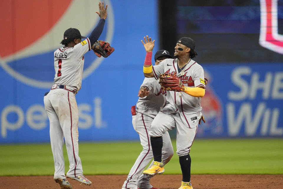 Atlanta Braves' Ozzie Albies (1) and Ronald Acuna Jr., right, celebrate after the Braves defeated the Cleveland Guardians in a baseball game Wednesday, July 5, 2023, in Cleveland. (AP Photo/Sue Ogrocki)