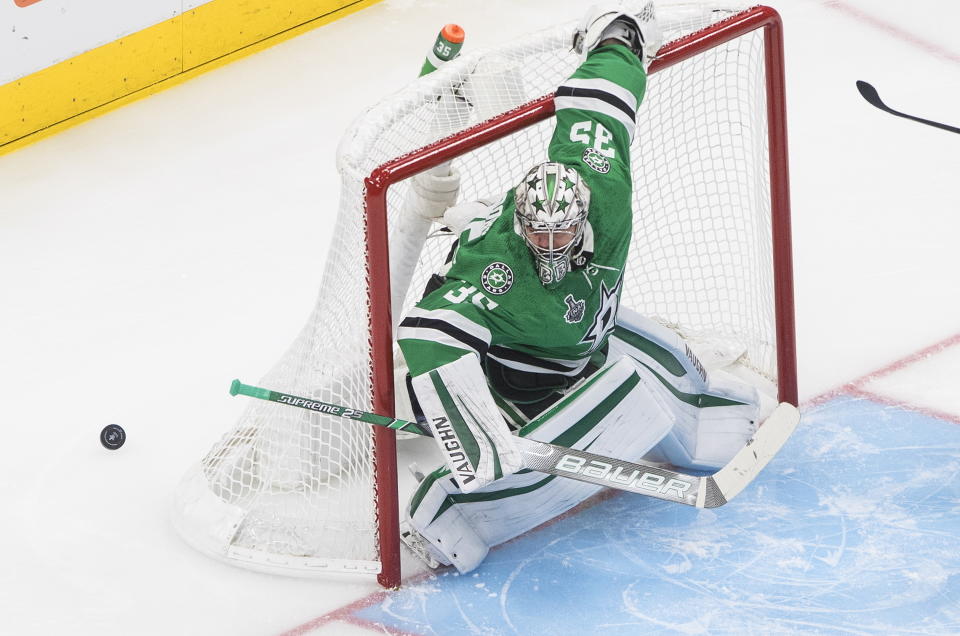 Dallas Stars goaltender Anton Khudobin turns the puck away during the first period against the Tampa Bay Lightning in Game 4 of the NHL hockey Stanley Cup Final, Friday, Sept. 25, 2020, in Edmonton, Alberta. (Jason Franson/The Canadian Press via AP)