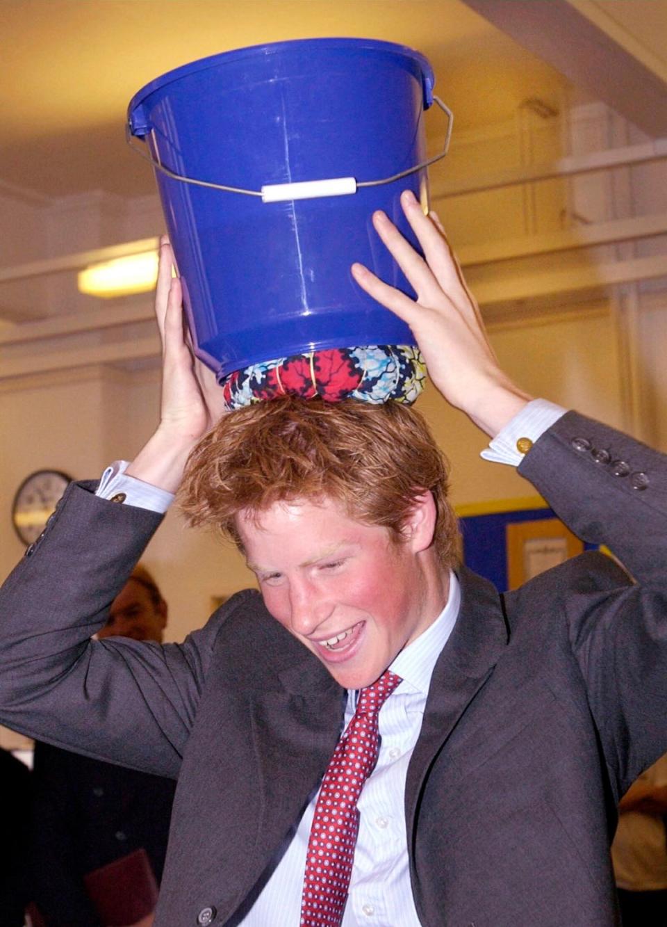 Prince Harry with a bucket on his head