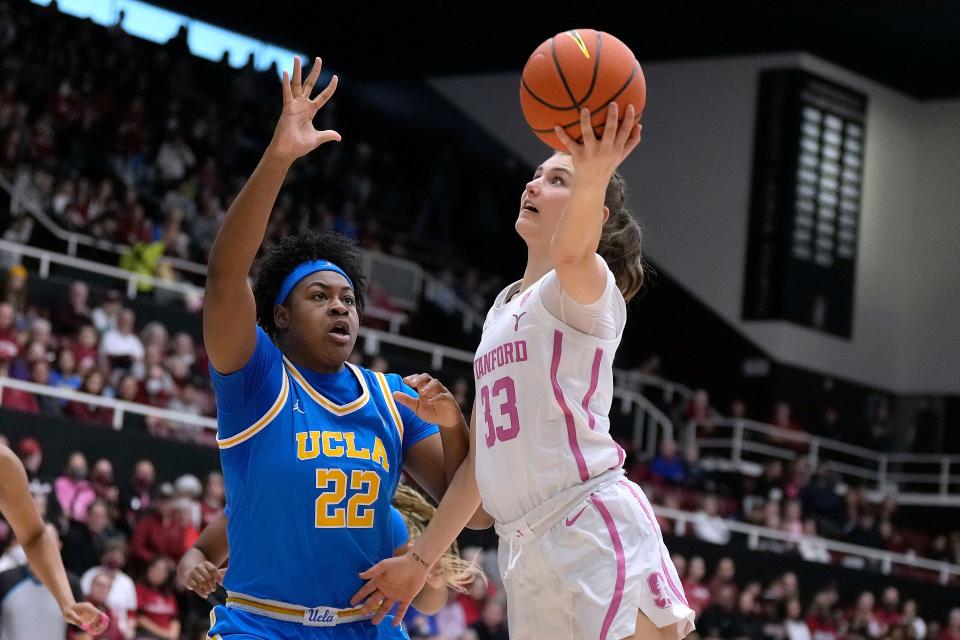 Stanford guard Hannah Jump (33) drives to the basket against UCLA forward Christeen Iwuala (22) during the first half of the game Sunday, Feb. 4, 2024, in Stanford, California.