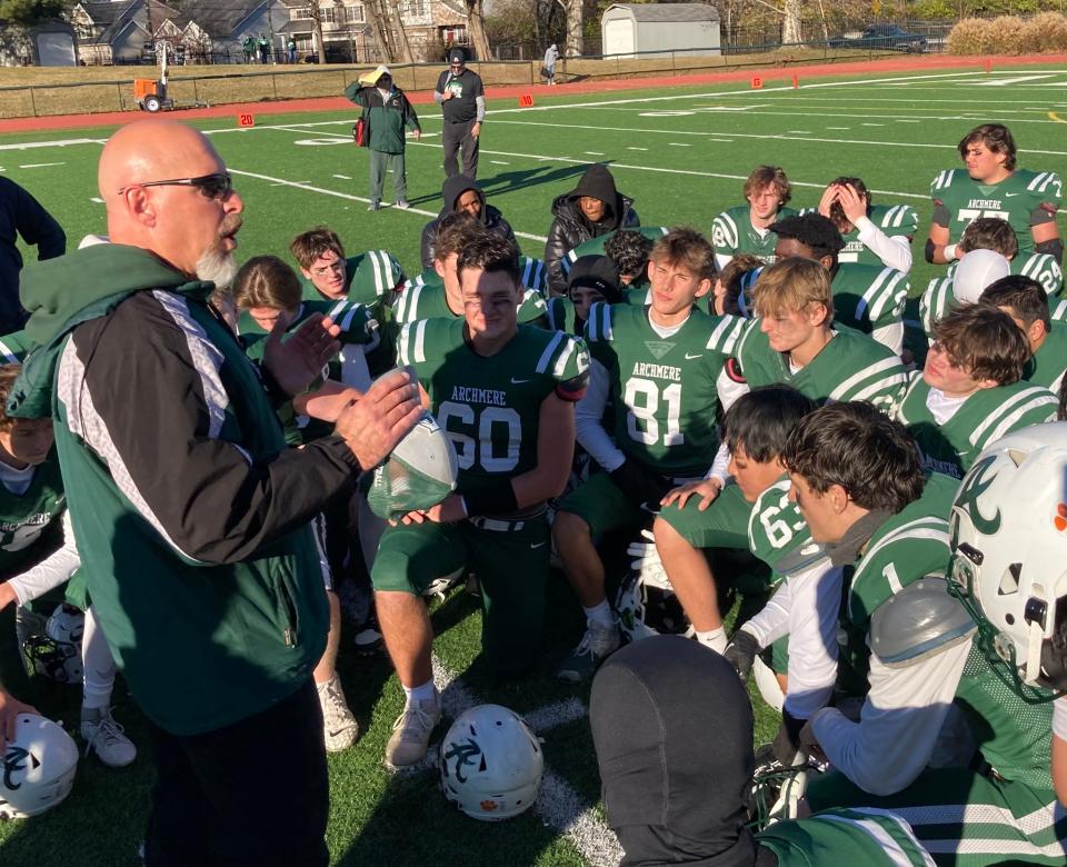 Archmere coach John Bellace (left) talks with his team following a 56-28 victory over Woodbridge in the Class 2A semifinals on Saturday at Coaches Field in Claymont.