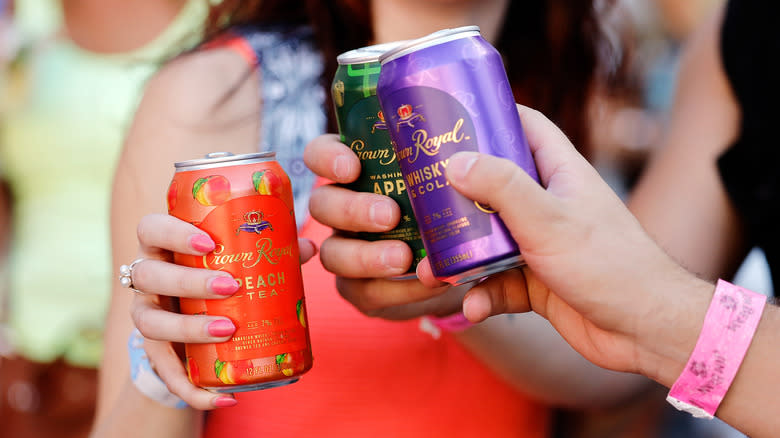 people drinking canned cocktails