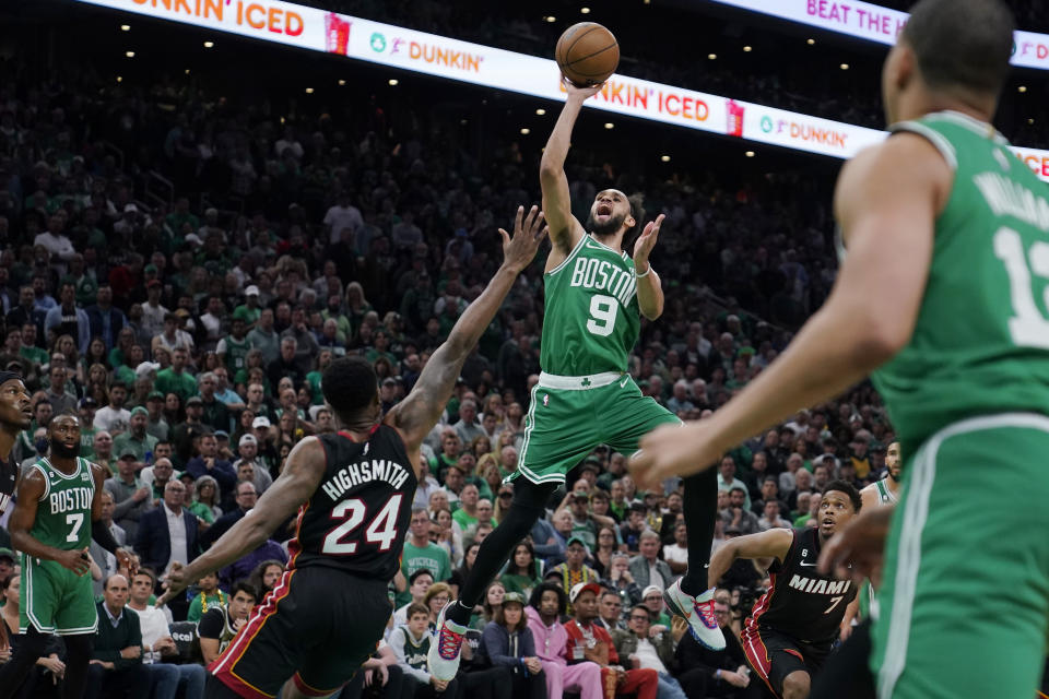 Boston Celtics guard Derrick White, center, shoots as Miami Heat forward Haywood Highsmith, second from left, defends while guard Jaylen Brown, left, and Grant Williams, right, watch during the second half in Game 7 of the NBA basketball Eastern Conference finals Monday, May 29, 2023, in Boston. (AP Photo/Charles Krupa )