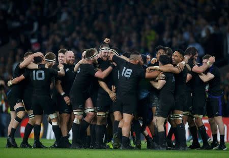 New Zealand players celebrate after beating Australia to win the Rugby World Cup final match at Twickenham in London, Britain, October 31, 2015. REUTERS/Paul Childs