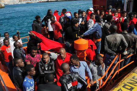 Migrants, intercepted aboard two dinghies off the coast in the Strait of Gibraltar, wait on a rescue boat to disembark after arriving at the port of Tarifa, southern Spain July 15, 2018. REUTERS/Jon Nazca