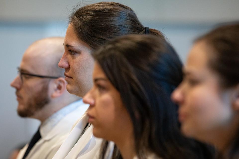 Doctors, from left, Griffin Geick, Katherine Hoffman, Chelsea Clark and Monica Campa listen to public comment against Christus Spohn's recent decision to terminate its emergency medicine residency program during a City Council meeting on Tuesday, Oct. 17, 2023, in Corpus Christi. Hoffman and Campa tear up during a speaker.