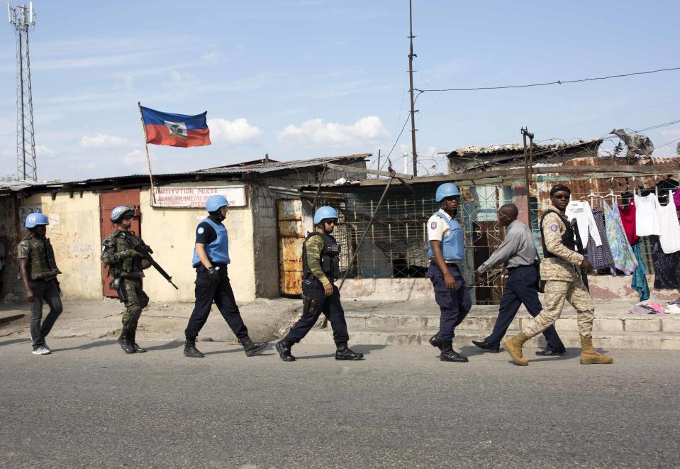 In this Feb. 22, 2017 photo, U.N. peacekeepers from Brazil patrol in the Cite Soleil slum, in Port-au-Prince, Haiti. For years, uniformed U.N. personnel provided the only real security here. But these days, Haiti's police do most of the heavy lifting. (AP Photo/Dieu Nalio Chery)