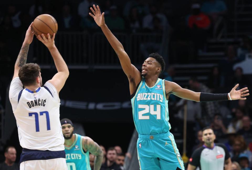 Dallas Mavericks guard Luka Doncic, left, releases a three-point shot over Charlotte Hornets forward/guard Brandon Miller, right, during first-half action on Tuesday, April 9, 2024 at Spectrum Center in Charlotte, NC.