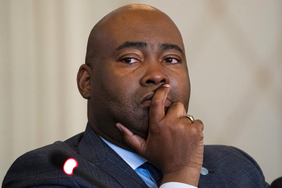 Democratic National Committee chair Jaime Harrison cries while listening to committee member Donna Brazile talk about the importance of proposed changes to the primary system during a DNC Rules and Bylaws Committee meeting to discuss President Joe Biden’s presidential primary lineup at the Omni Shoreham Hotel on Friday, Dec. 2, 2022, in Washington. (AP Photo/Nathan Howard)