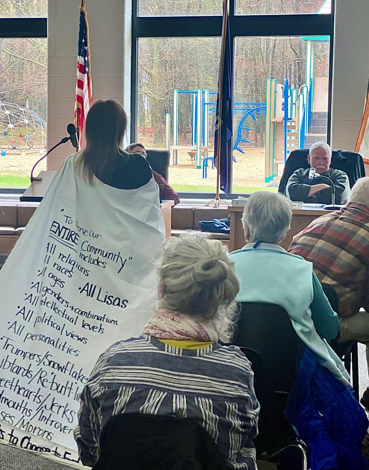 An audience member at the Health Department of Northwest Michigan Board of Health meeting on May 2 donned a cape with a message during the recess when staff consulted their attorney for advice on whether to move on without an approved agenda.