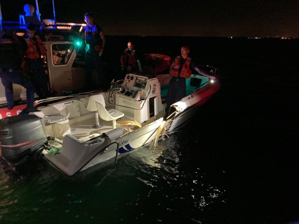Coast Guard Station Miami Beach small boat crew inspecting a boat that was part of a collision near Key Biscayne, Florida, June 17, 2022.