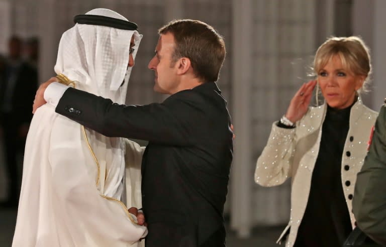 Abu Dhabi Crown Prince Mohammed bin Zayed Al-Nahyan greets French President Emmanuel Macron (C) and his wife Brigitte Macron at the entrance of the Louvre Abu Dhabi Museum on November 8, 2017 during its inauguration