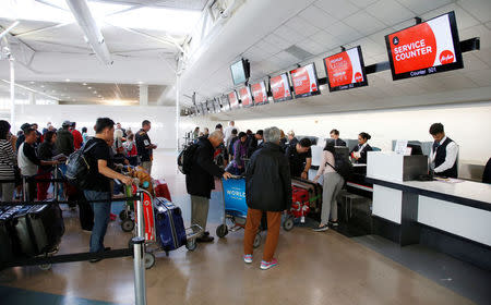 Air Asia passengers check-in at Auckland Airport during fuel shortages in New Zealand, September 20, 2017. Picture taken September 20, 2017. REUTERS/Nigel Marple