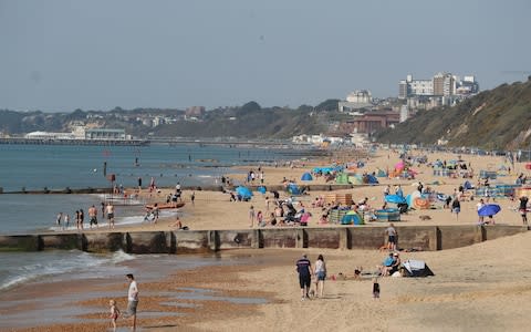 Holidaymakers took to Boscombe Beach in Dorset with their towels and swimming gear - Credit: Andrew Matthews/PA