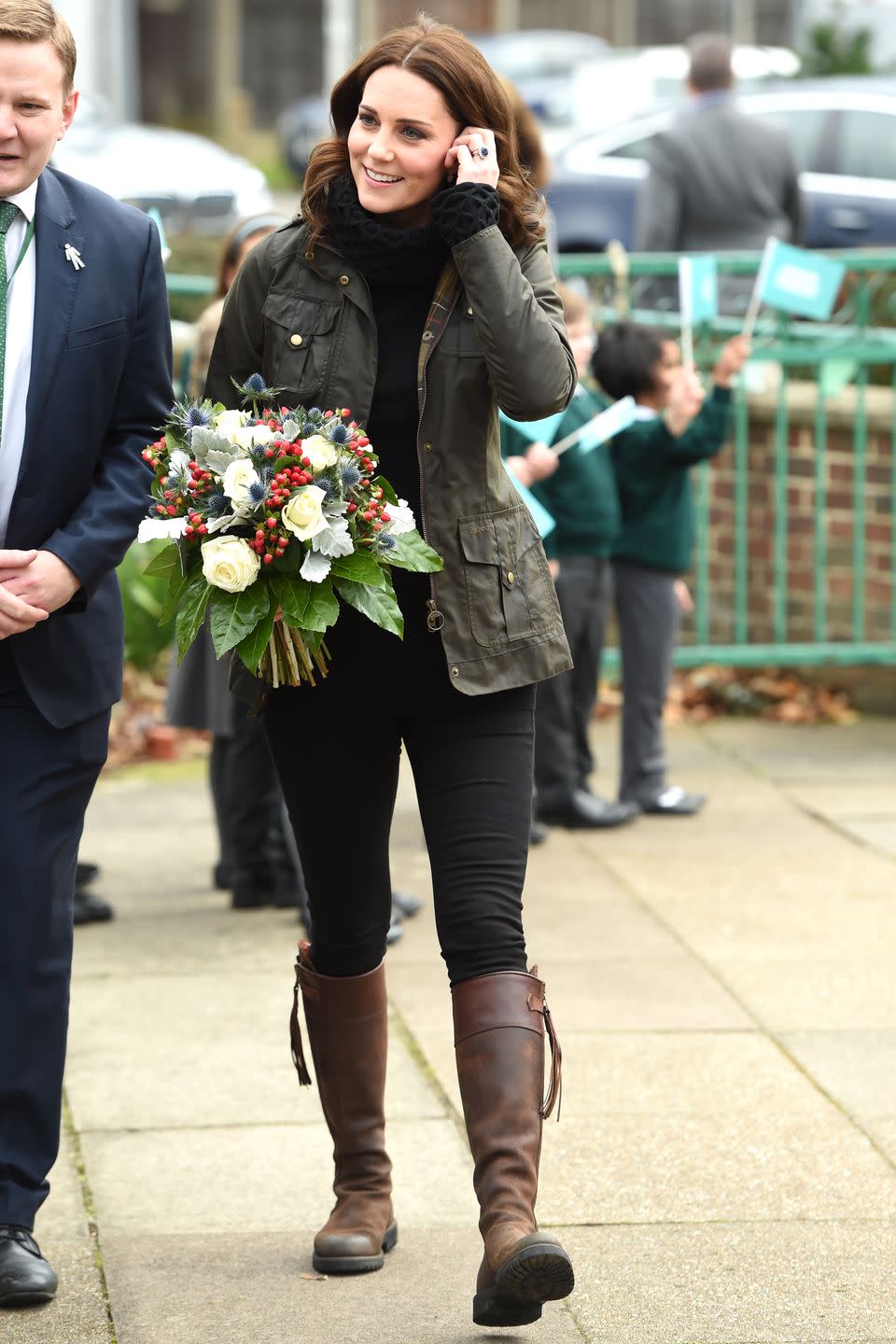 <p>The Duchess wears an army green cargo jacket, Temperley London turtleneck sweater, skinny jeans, and Penelope Chilvers brown leather tassel boots during a visit to Robin Hood Primary School.</p>