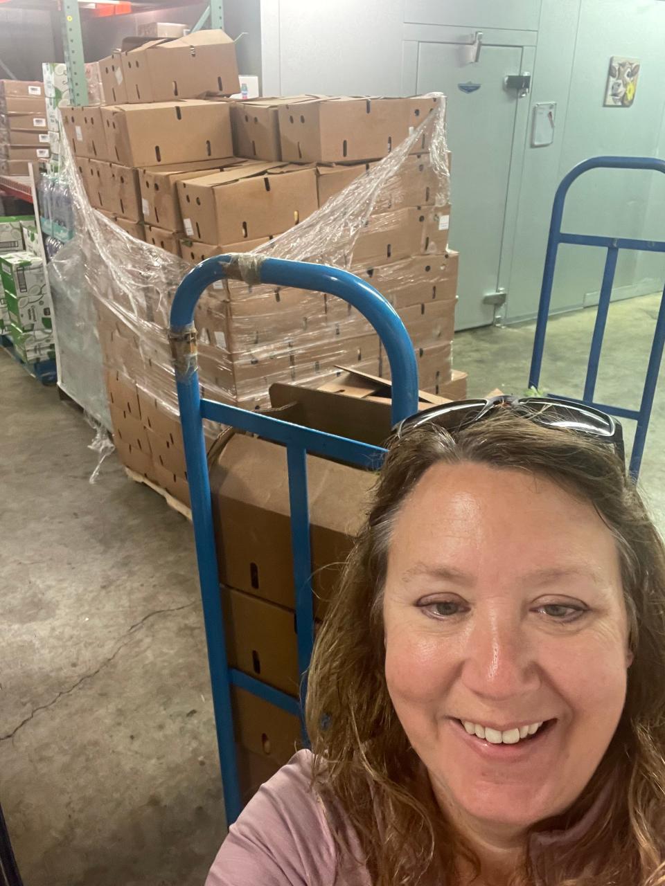 Rochelle Gamauf, the executive director of Friends With Food, stands near produce boxes that will help fill the shelves of the nonprofit's facility at 713 N. Grandview Blvd. in Waukesha. Friends With Food, which launched in 2020 during the COVID-19 pandemic, depends on fundraisers, including its Dec. 2 Santa With Friends breakfast, to cover increased overhead costs to serve a growing clientele.