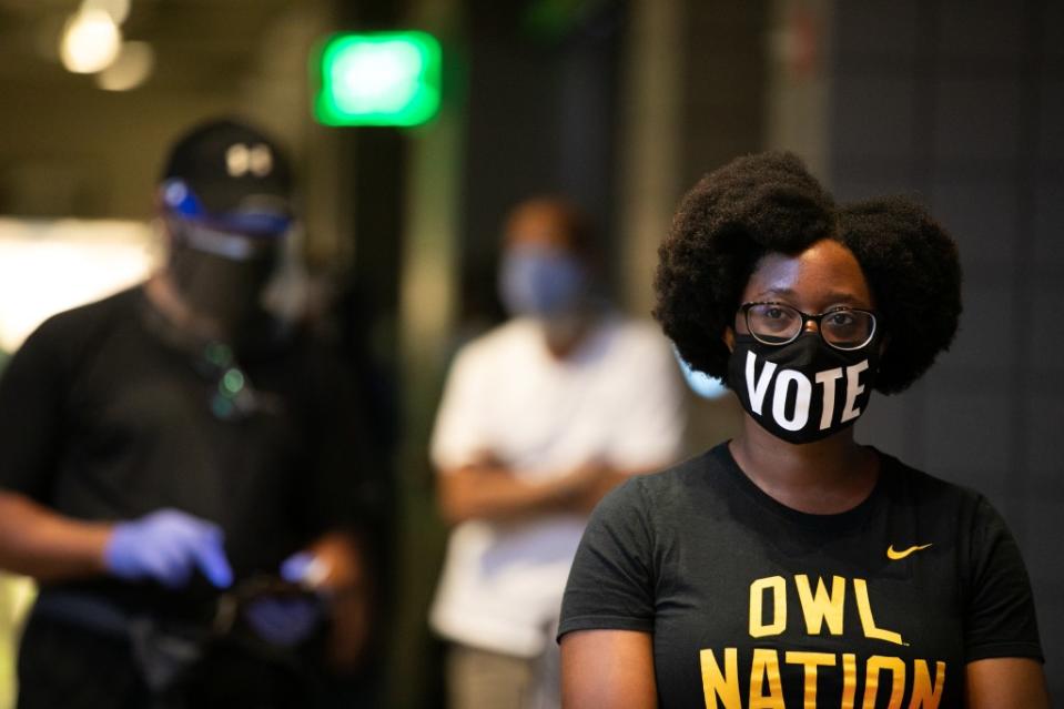 Ashley Nealy waits in line in Atlanta in October 2020 on the first day of early voting. This year, Georgia is again one of the battleground states the Biden-Harris campaign is targeting. (Photo by Jessica McGowan/Getty Images)