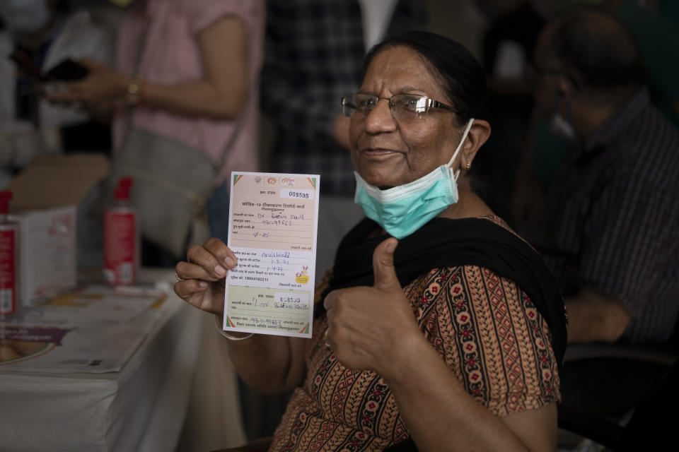 A beneficiary gestures after getting a COVISHIELD vaccine shot at a government hospital in Noida, a suburb of New Delhi, India, Monday, March 1, 2021. India is expanding its COVID-19 vaccination drive beyond health care and front-line workers, offering the shots to older people and those with medical conditions that put them at risk. As of Monday, those eligible to be vaccinated include people over 60, as well as those over 45 who have ailments such as heart disease or diabetes that make them vulnerable to the coronavirus. (AP Photo/Altaf Qadri)