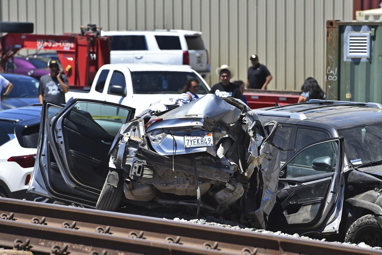 A vehicle is damaged after colliding with an Amtrak train in Brentwood, Calif., on Sunday, June 26, 2022. 
