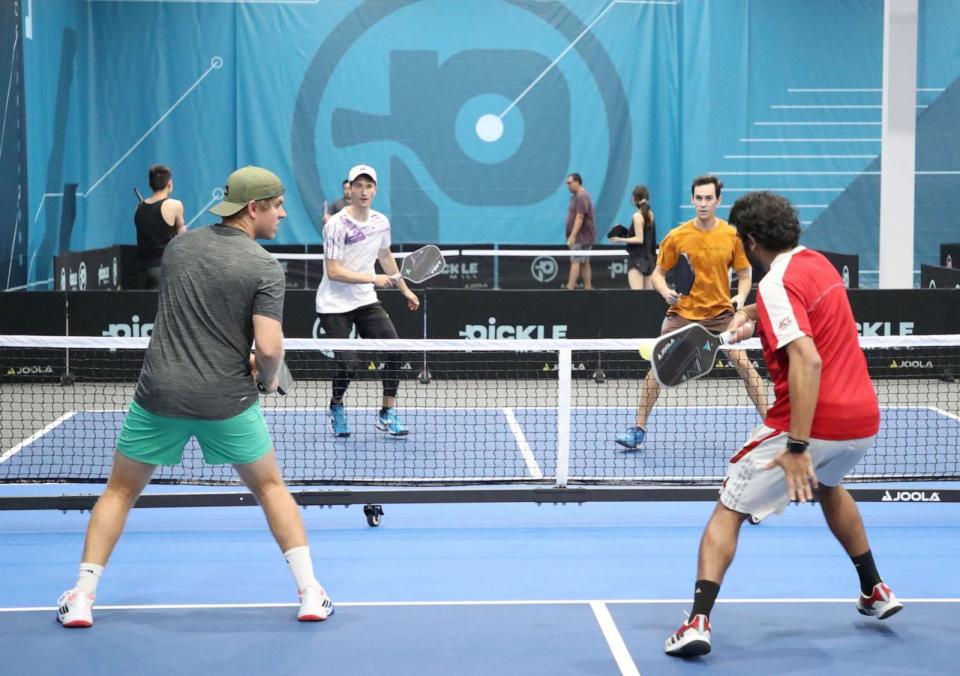 PHOTO: Four pickleball players engage in a net battle at Picklemall located at the Arizona Mills Mall, Aug. 5, 2023 in Tempe, Arizona. (Bruce Yeung/Getty Images)