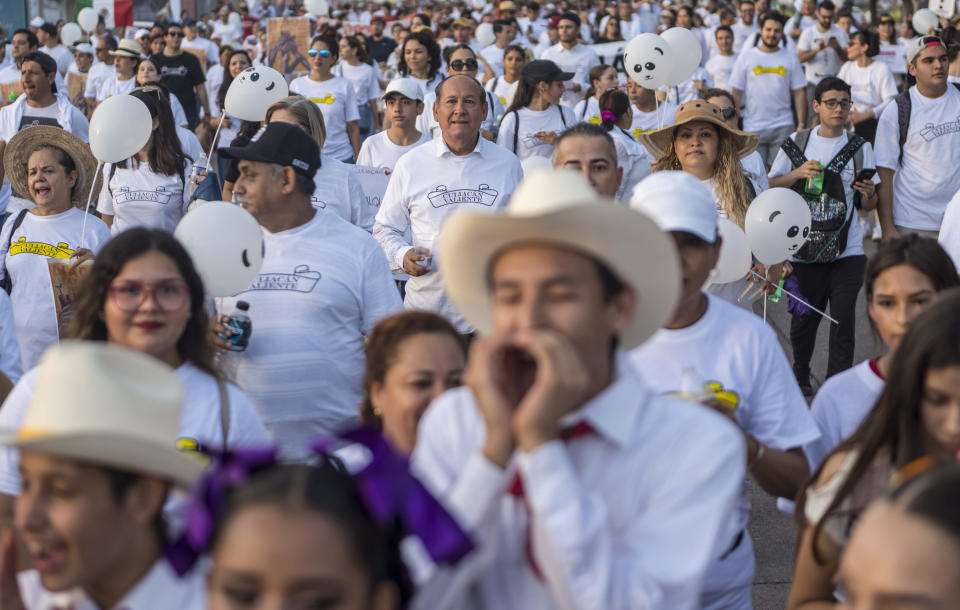 People attend a march coined "Culiacan Valiente," or Brave Culiacan, to protest violence and demand safety in Culiacan, Mexico, Sunday, Oct. 27, 2019. Residents are still coming to grips with the worst cartel violence in recent memory, in which 13 people were killed including at least three innocents caught in the crossfire, on Oct. 17, a date now known as “Black Thursday.” (AP Photo/Augusto Zurita)